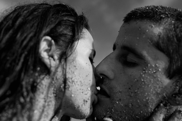 Couple on beach kissing - wedding photo by Adagion Studio